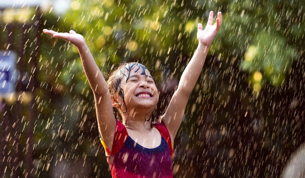 asian-children-playing-in-the-rain-are-happy